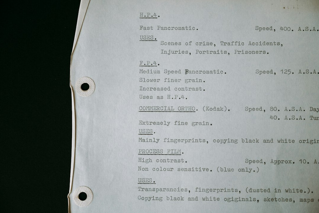 Hand writing crisis response notes on a broadcast protocol sheet